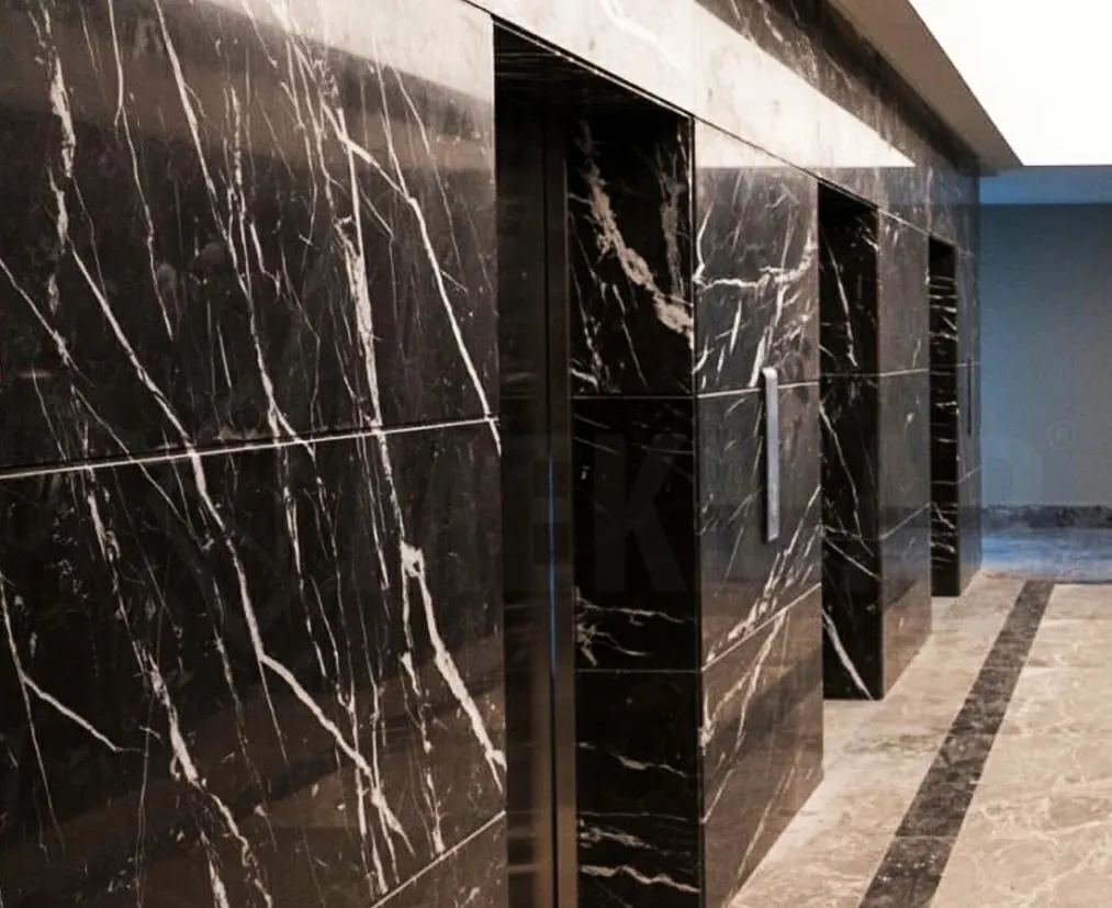 Black marble cladding in an elevator hall