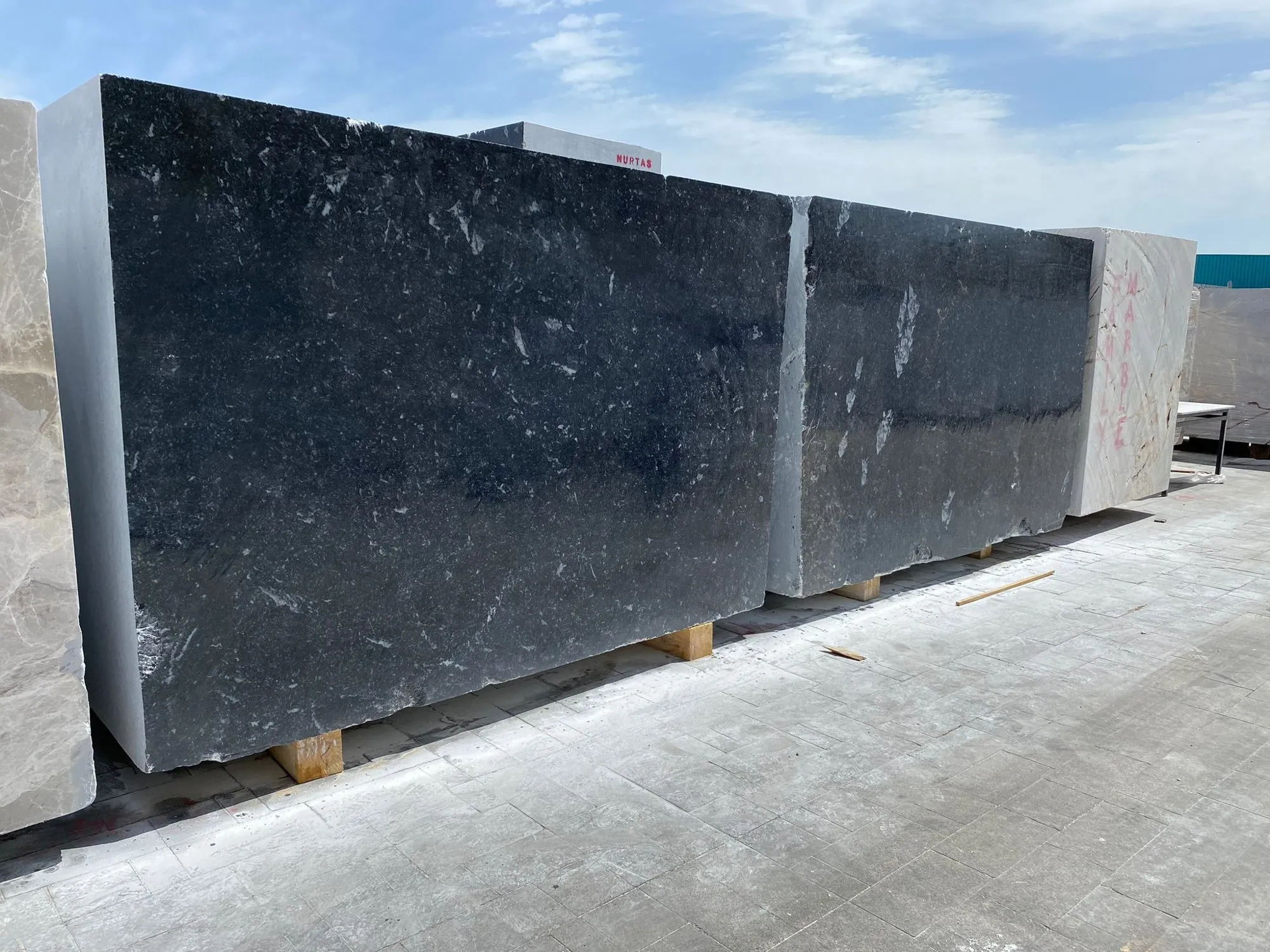 Black marble slabs stacked in the stock yard