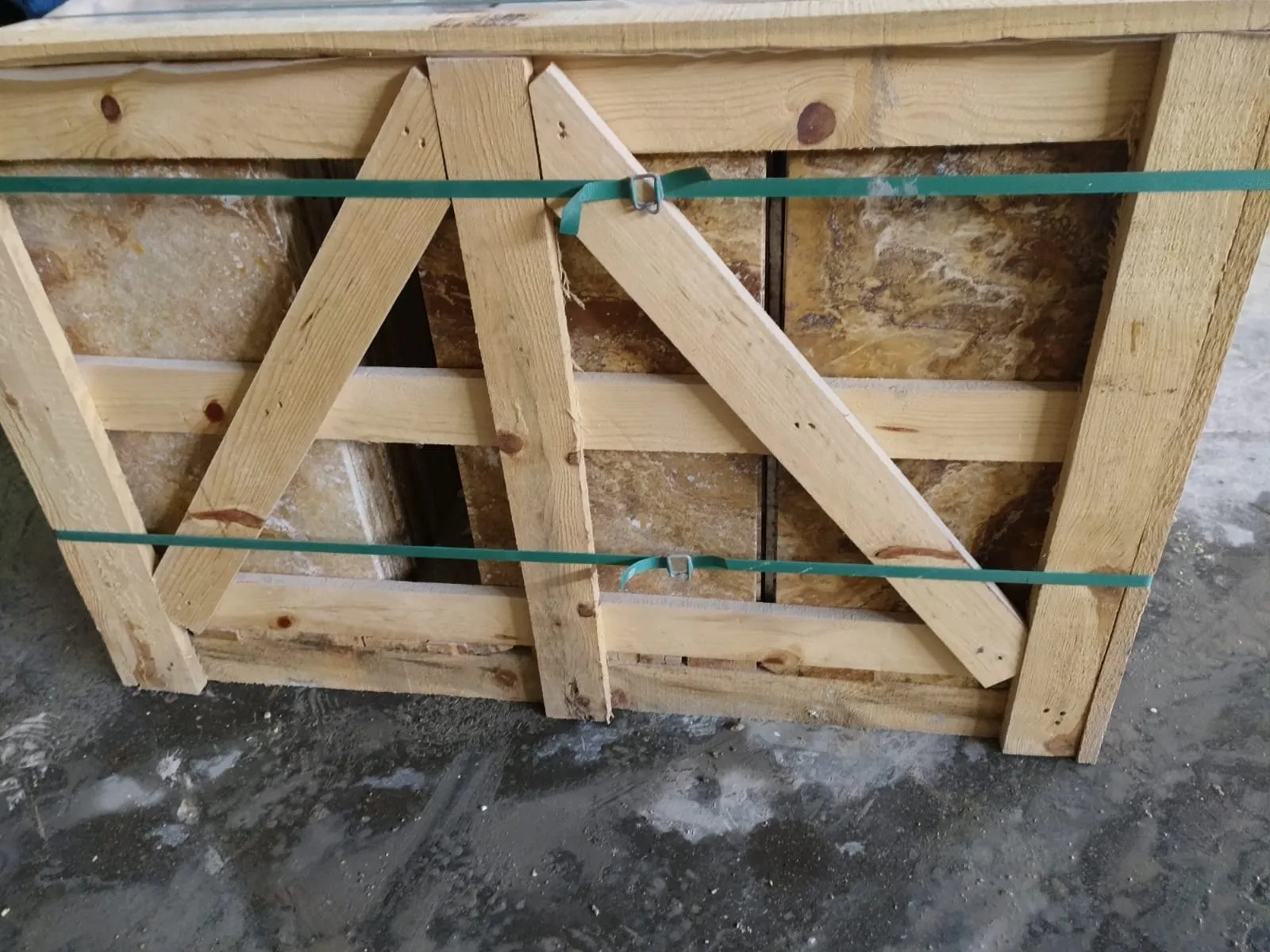 Strapped wooden export crate holding travertine