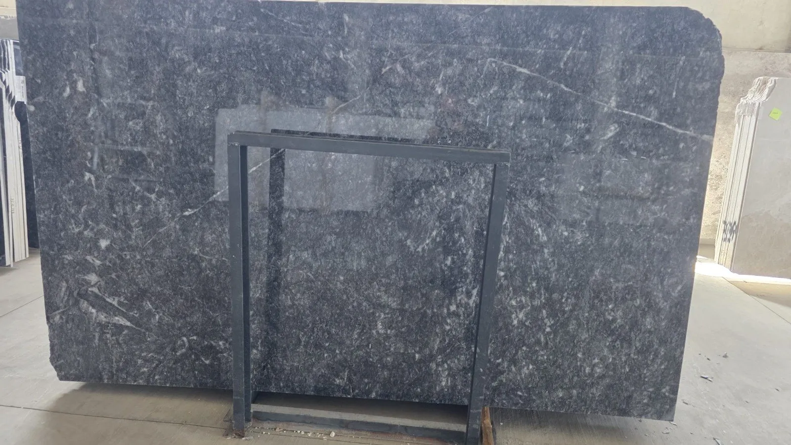 Polished Turkish black marble slab showing white veining